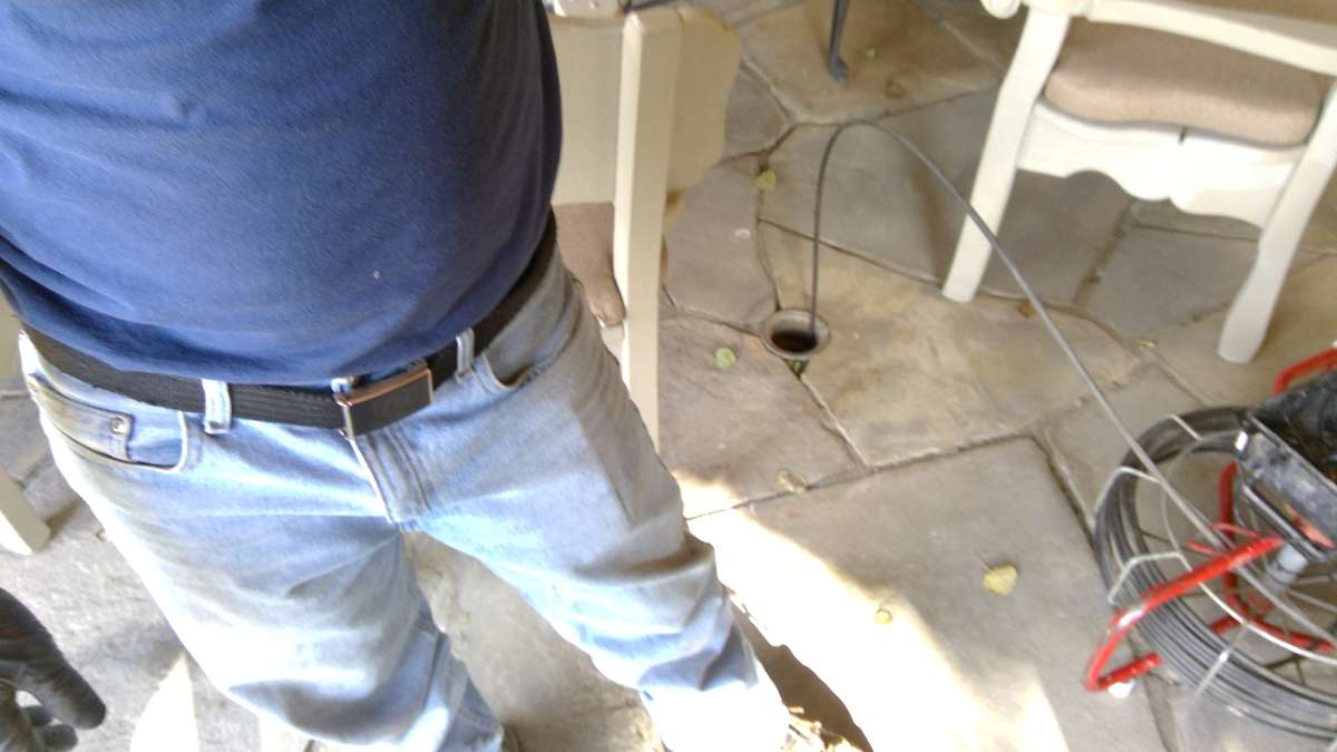 Technician Performing Drain Cleaning Service