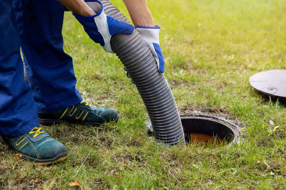 Sweet’s Services technician pumping a septic tank